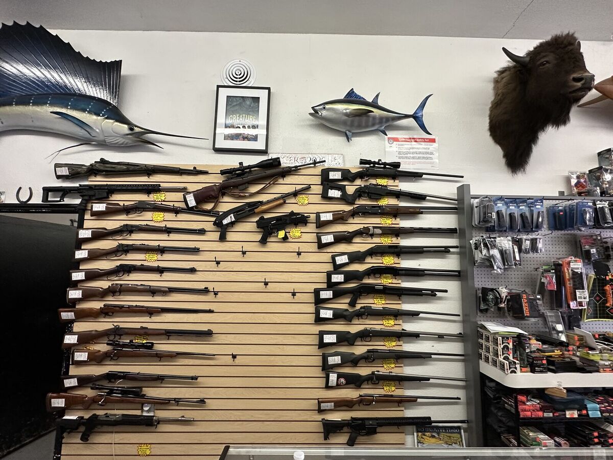 A wall of rifles and shotguns for sale inside Legacy in Mesa, AZ